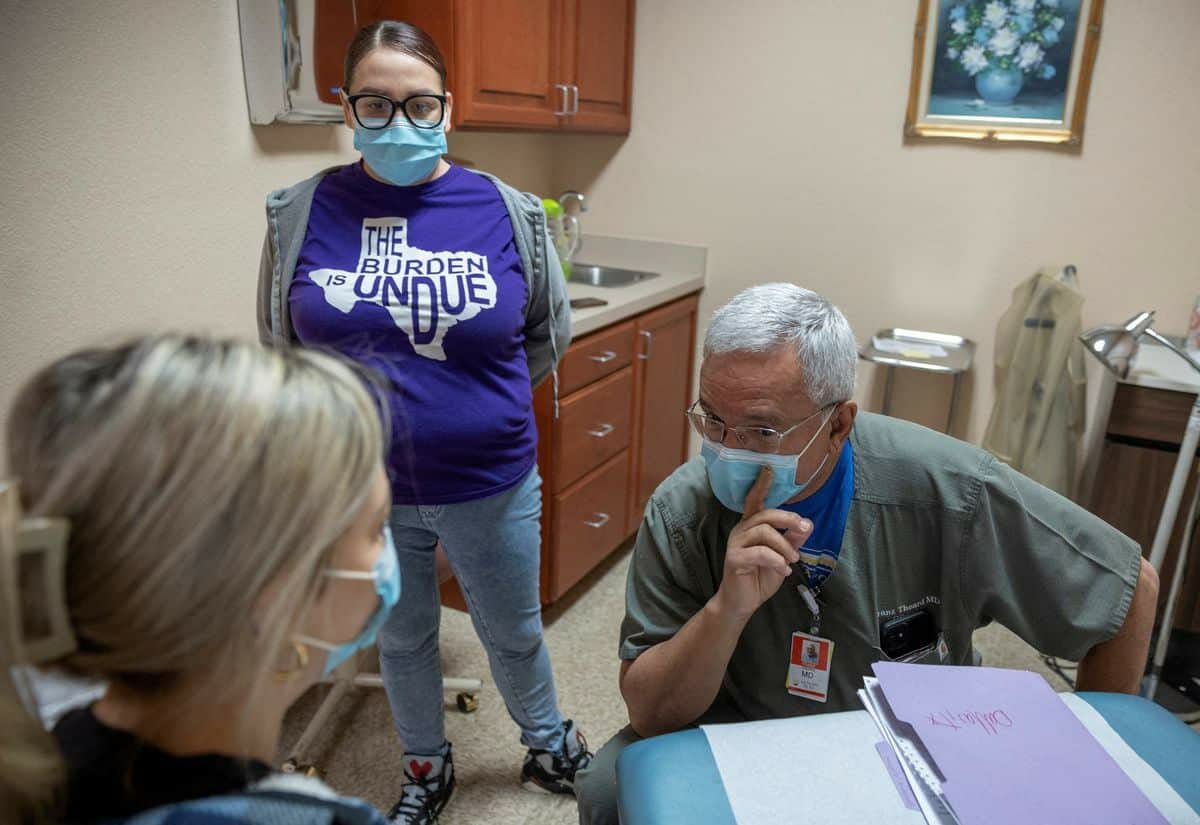 [2/7] Dr. Franz Theard speaks to a patient with medical assistant Elizabeth Hernandez, at his clinic, Women's Reproductive Clinic of New Mexico in Santa Teresa.