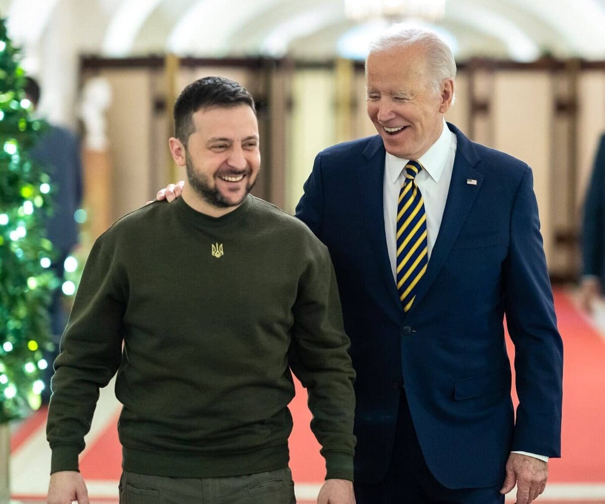 Presidents Joe Biden and Volodymyr Zelenskyy walking together and laughing