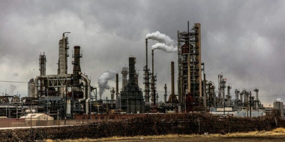 Chemical disasters. Climate change a factory expelling pollution into a dark, dismal sky