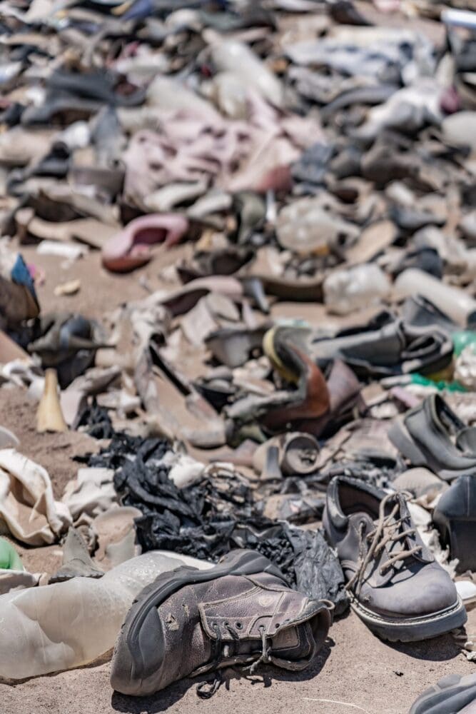 Chile desert boots among other shoes at an illegal clothing dump site