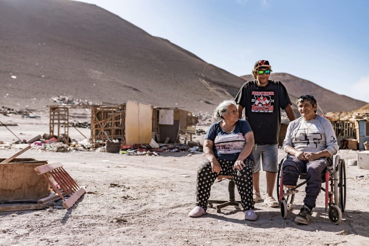 Family sits at dump site in desert of Chile