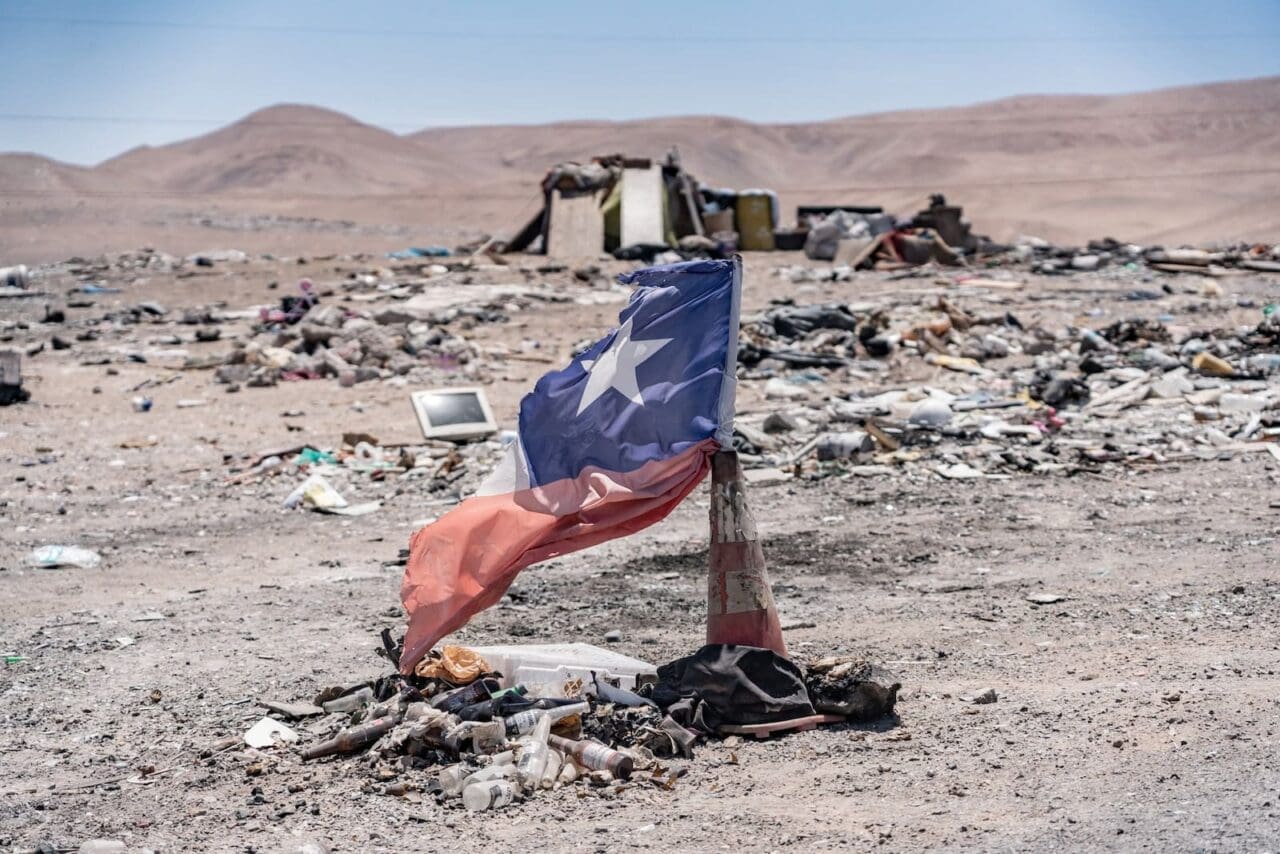 Chile flag sticks out of a traffic cone in the desert