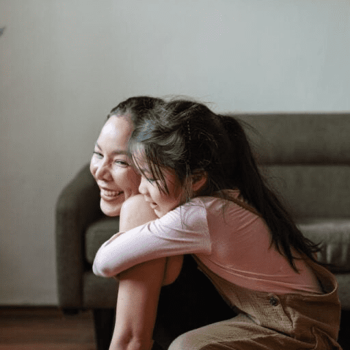 Child on mother’s back hugging her