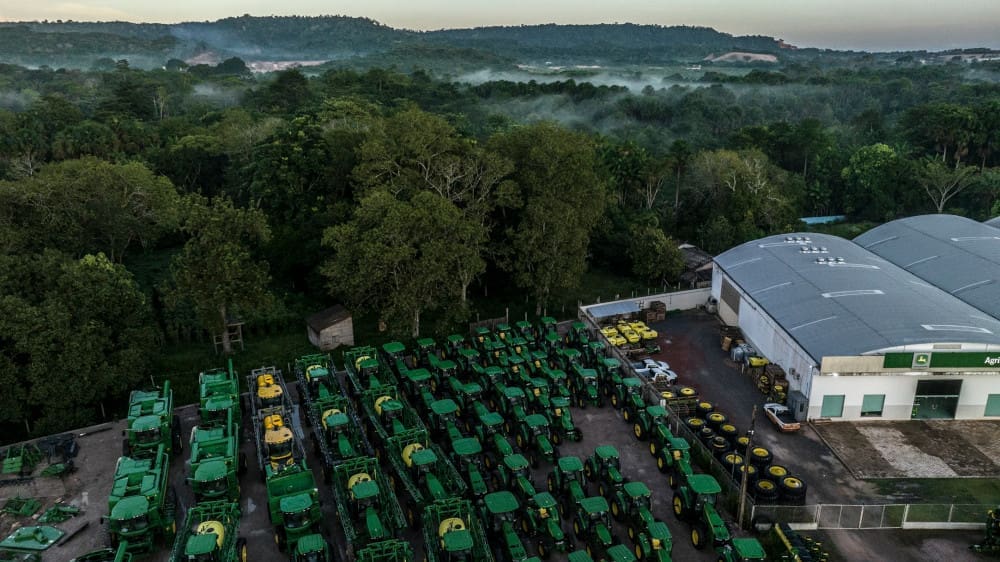Rows of green tractors at a distributor near the Amazon