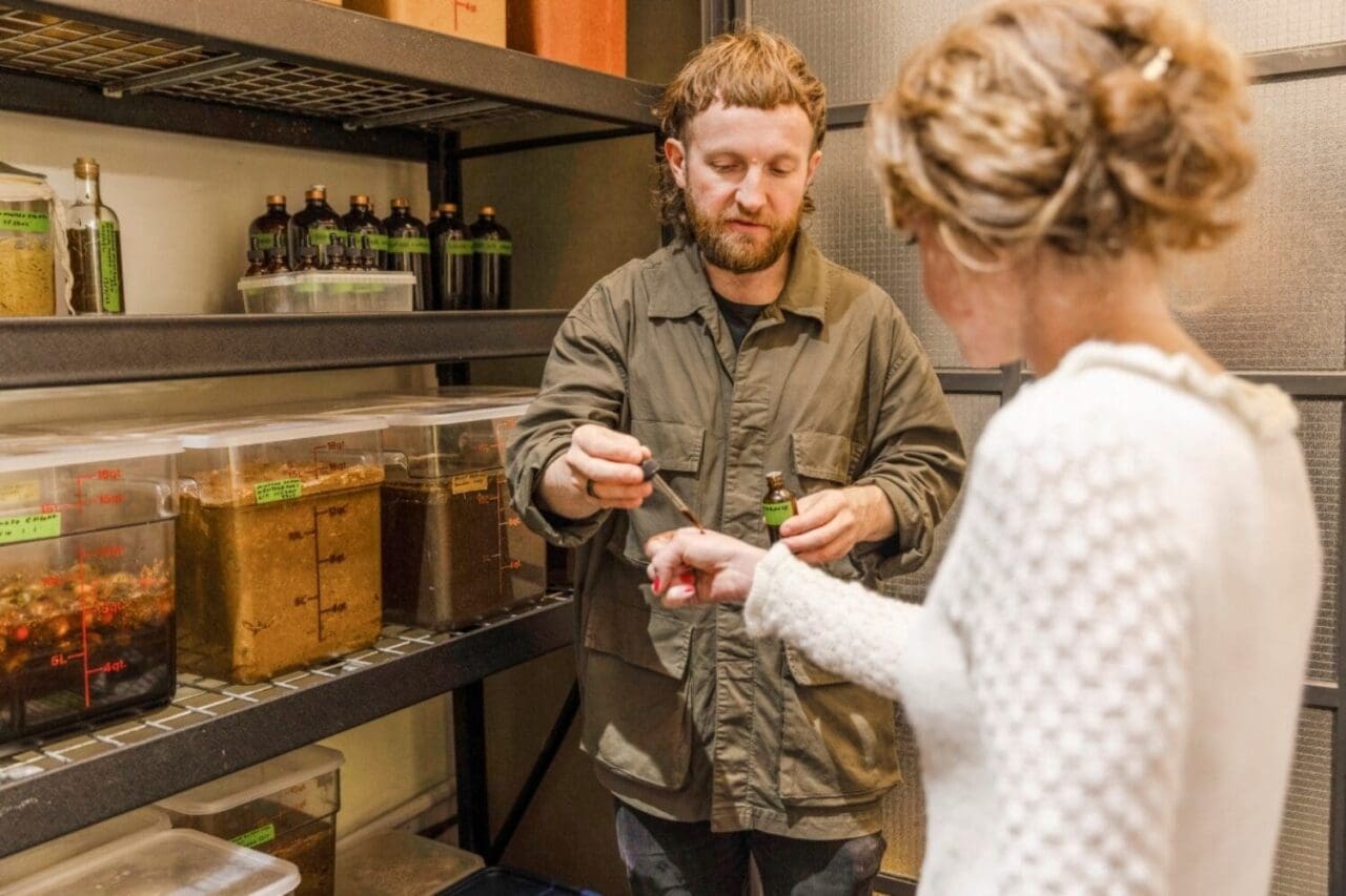 Man offering a woman a taste of the food he just made