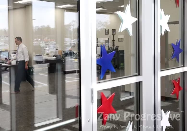 Looking through red white and blue star decorations on a glass door into an office