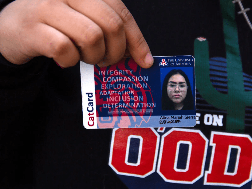 Alina holds upher student id