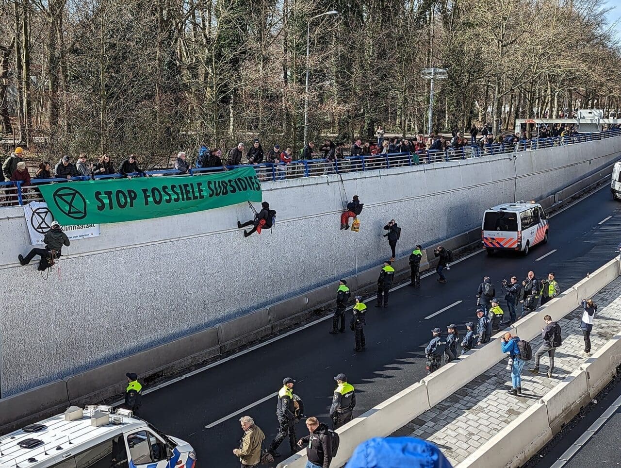 A banner displayed above a freeway by environmental activist group Extinction Rebellion