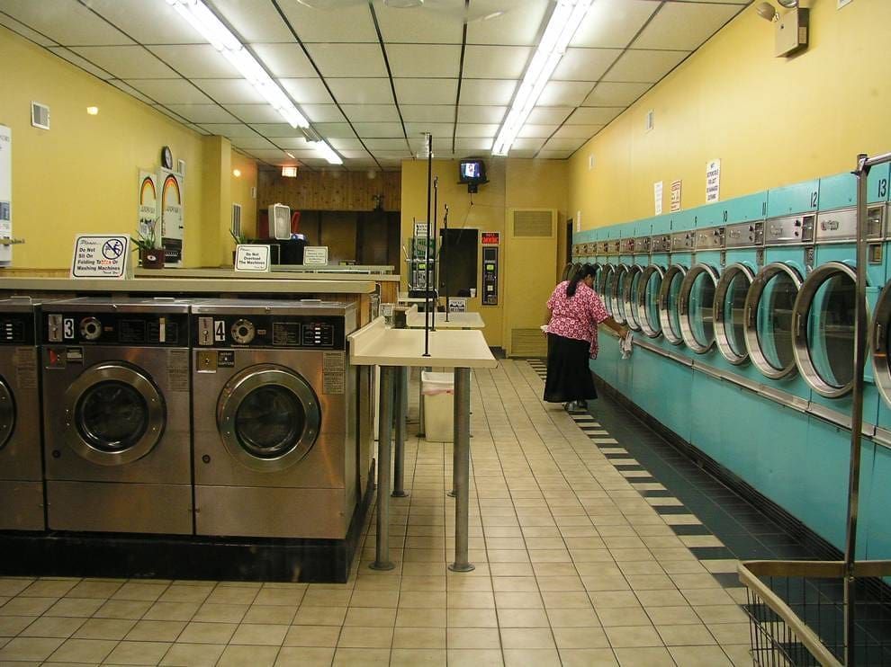 A woman doing laundry at a laundromat in Chicago.