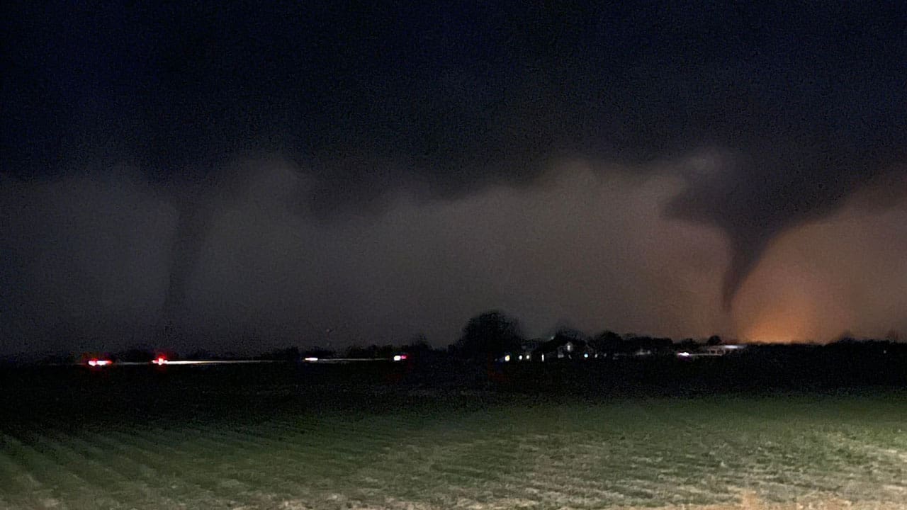 Photo of a tornado in a very dark outside environment