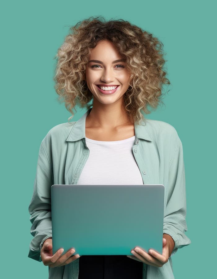 Woman with frosted hair and a light green shirt holding a laptop