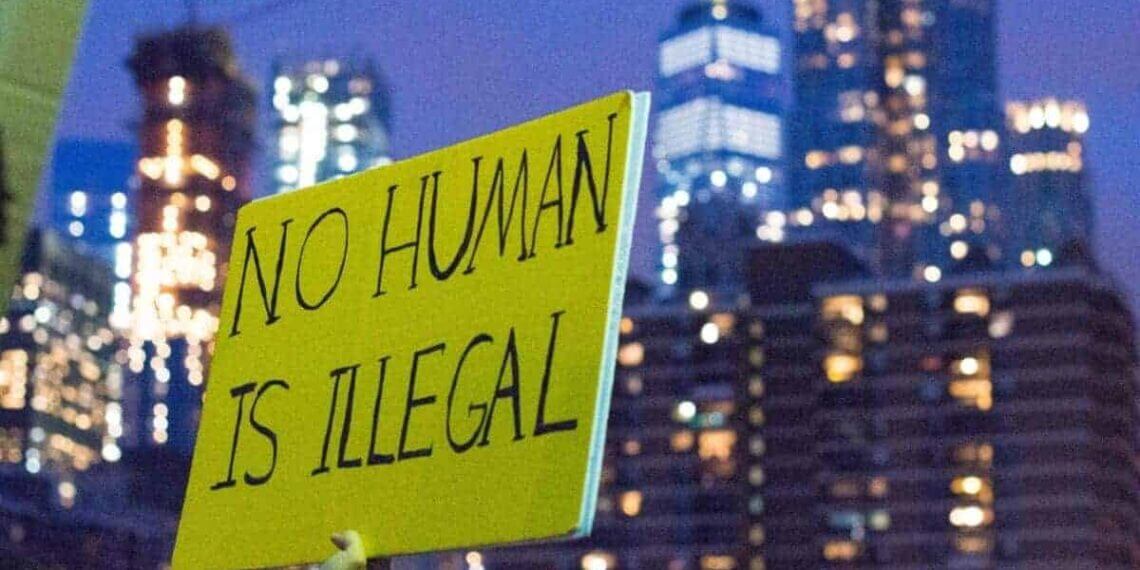 Immigration and daca protections protest sign that says no human is illegal