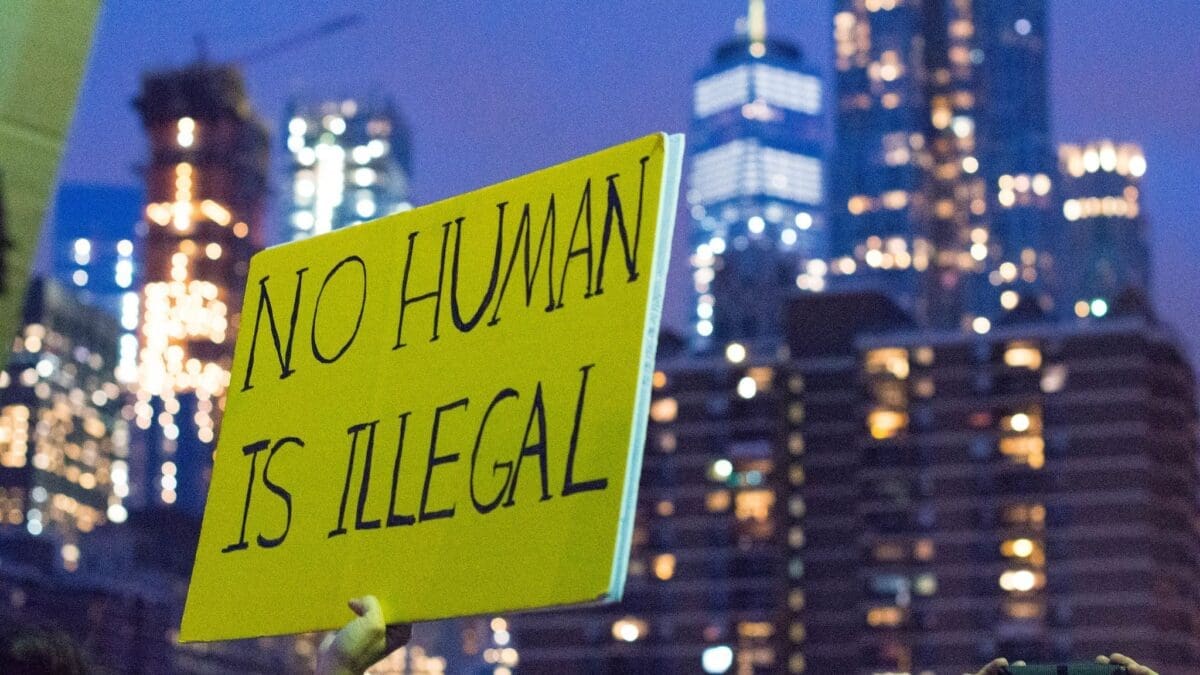 Immigration and daca protections protest sign that says no human is illegal