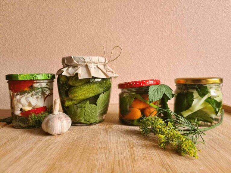 Jars of fermented foods on a wooden counter or table