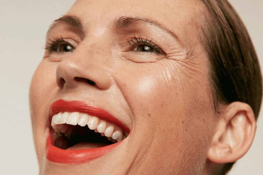 Beautiful woman wearing red lipstick laughing