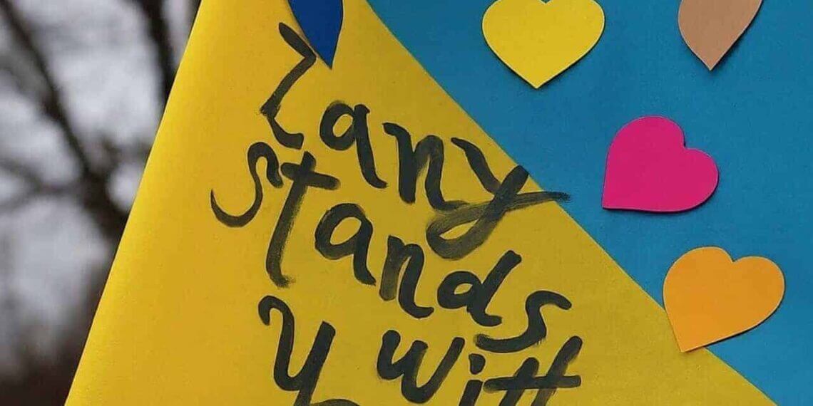 War in ukraine: ukranian flag with hearts and written in black marker: zany stands with you. ”