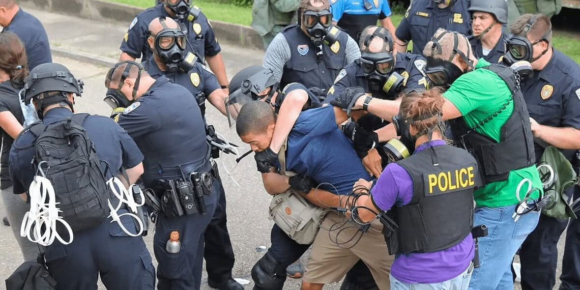 Filming police is getting closer to being outlawed, police wrangling people during a protest with one using a chokehold.