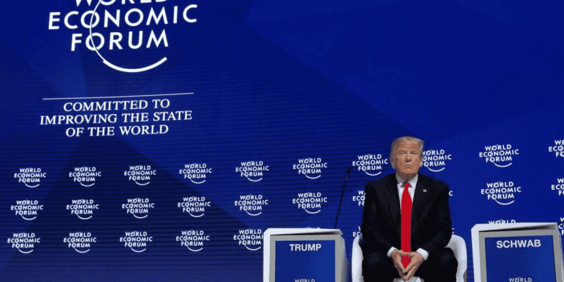 Donald trump sitting on stage at a convention