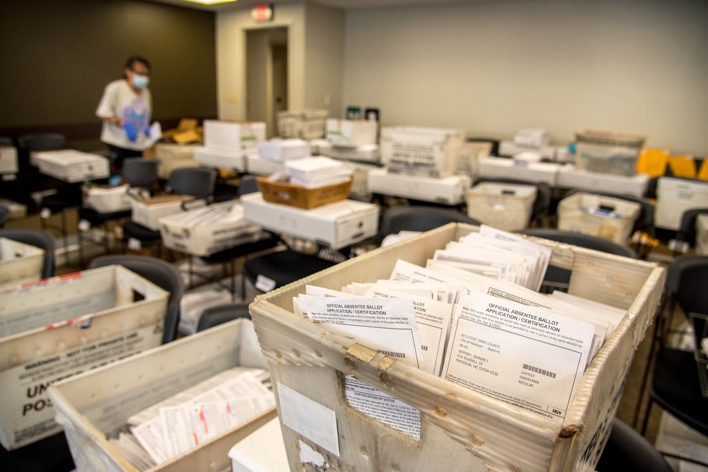 Boxes of absentee ballots are sorted by ward in a room at the Madison, Wis., City County Building on Aug. 5, 2020, ahead of the Aug. 11 election.