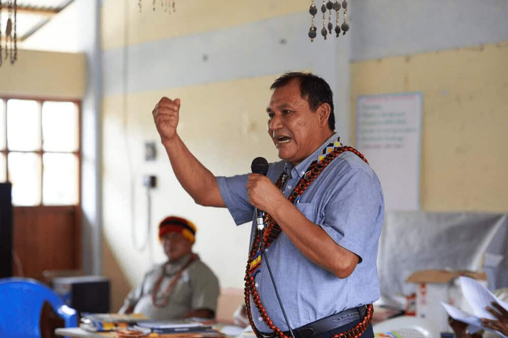 A man speaks to volunteers working to save the peruvian rainforest