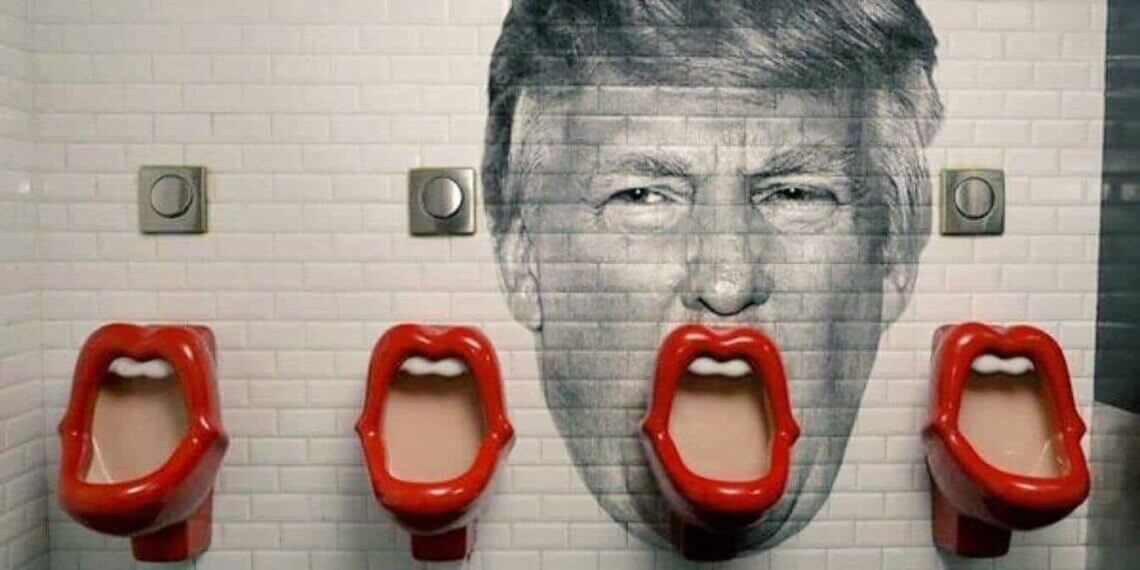 Trump's face painted on the wall behind a urinal so it looks like his mouth
