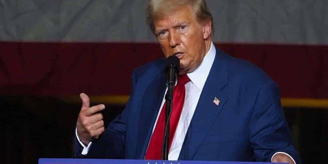Trump on stage at a rally in michigan