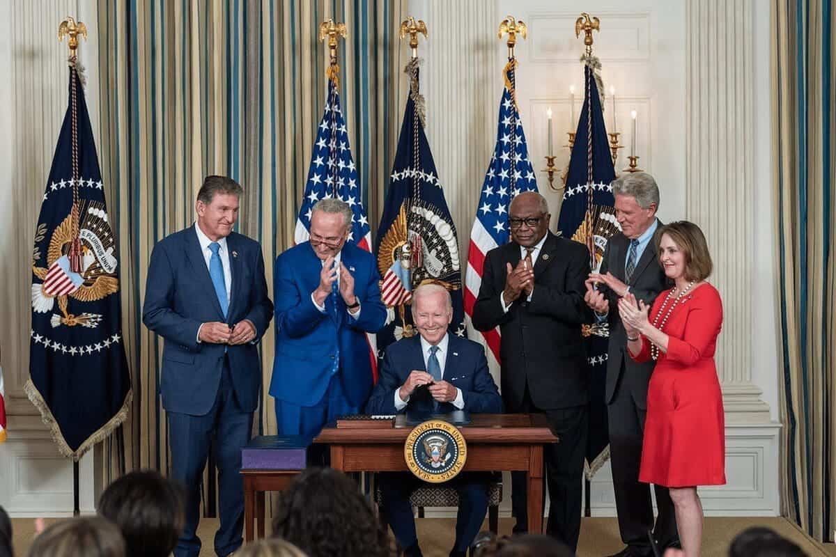 Democrats around president biden as he signed the infrastructure bill with climate provisions