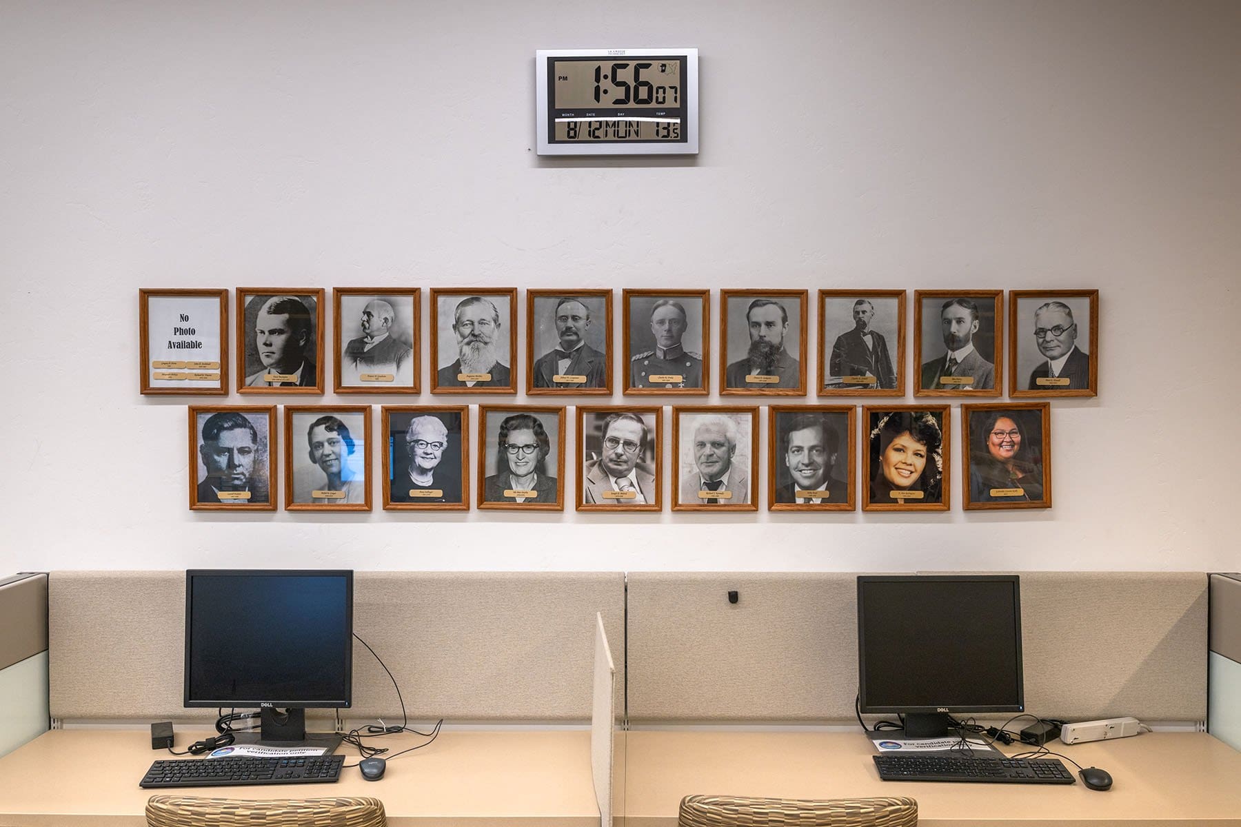 A wall displays framed portraits of Pima County Recorders, including Cázares-Kelly, at her offices. 