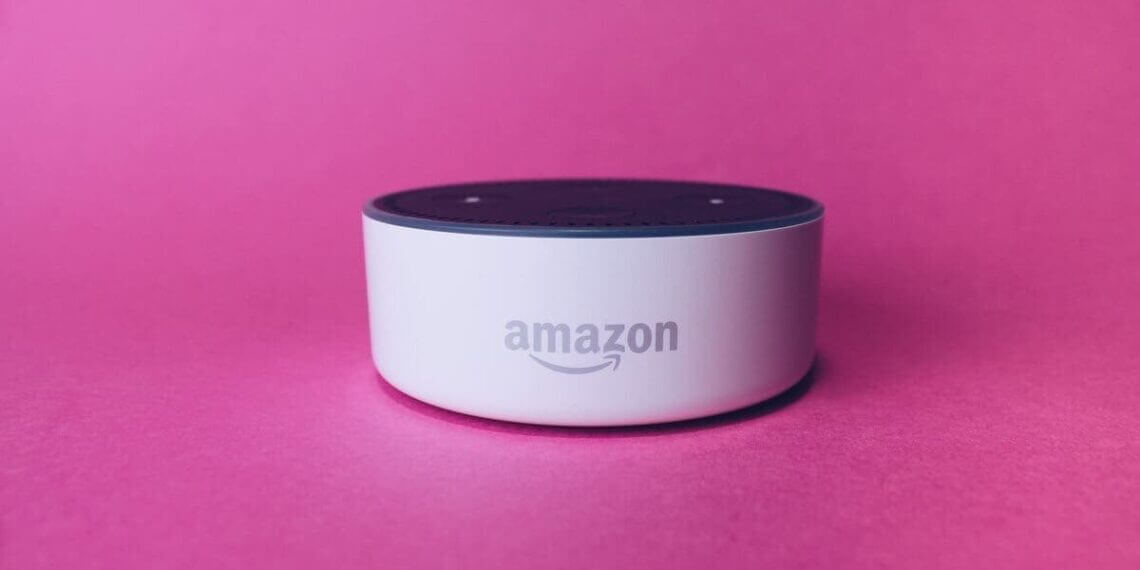 Amazon alexa dot device surrounded by the color pink