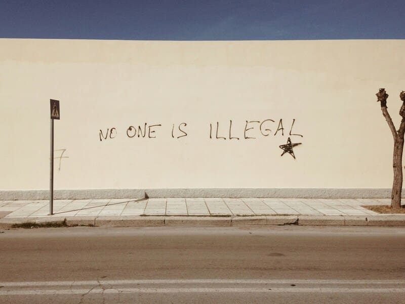 Immigration policy in the united states: No one is illegal painted on a wall