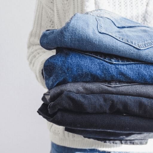 Stack of 3 different colors of sustainable fashion jeans