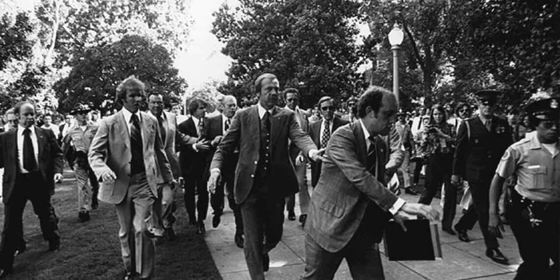 Following the september 5, 1975 10:04 am[1] attempt on u. S. President gerald ford's life by cultist charles manson family member lynette "squeaky" fromme, secret service agents rush president ford towards the california state capitol in sacramento.