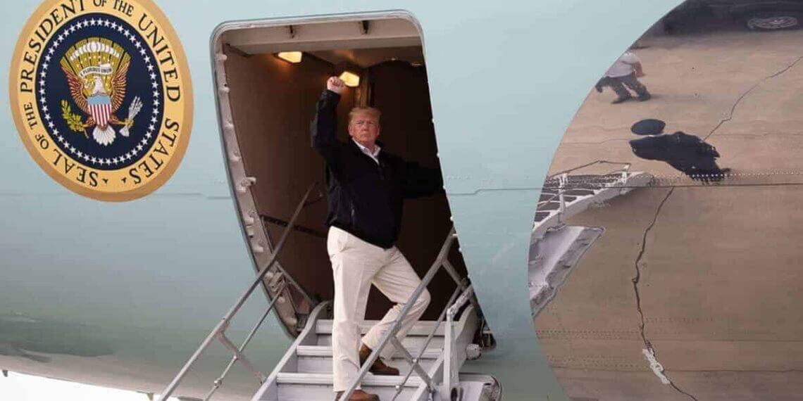 Donald trump raising his fist as he boards a plane