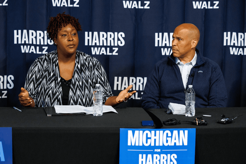 U.S. Sen. Cory Booker (D-N.J.), right, and Flint City Council President Ladel Lewis, left, participate in a roundtable with small business owners in Flint, Mich., on Sept. 20, 2024.