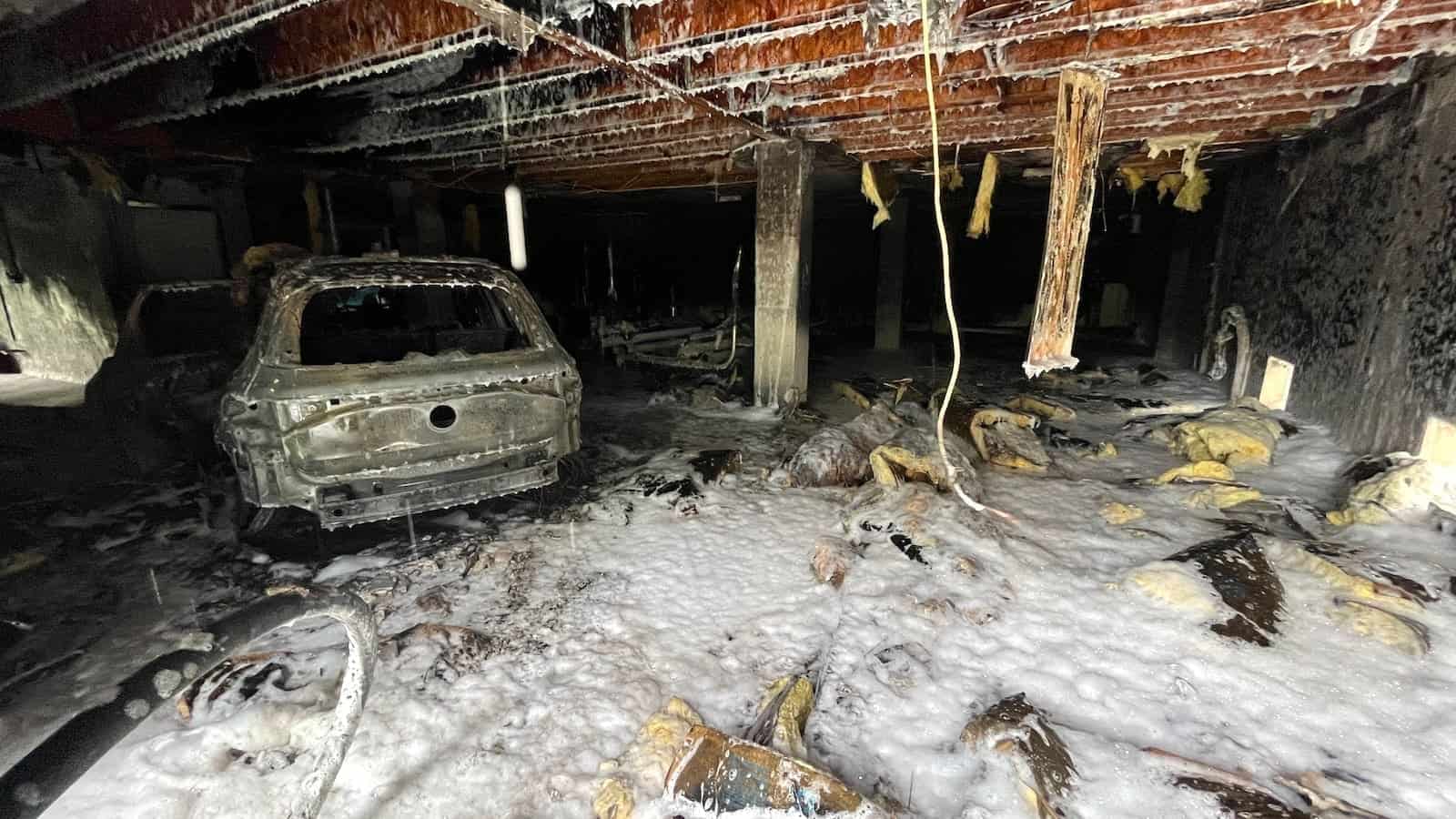 Ev batteries concern first responders: a vehicle and garage covered in the foam used to extinguish fires.