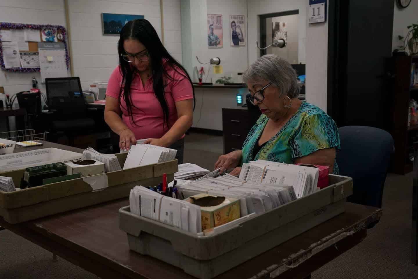 A clerk looks through texas paper registration forms