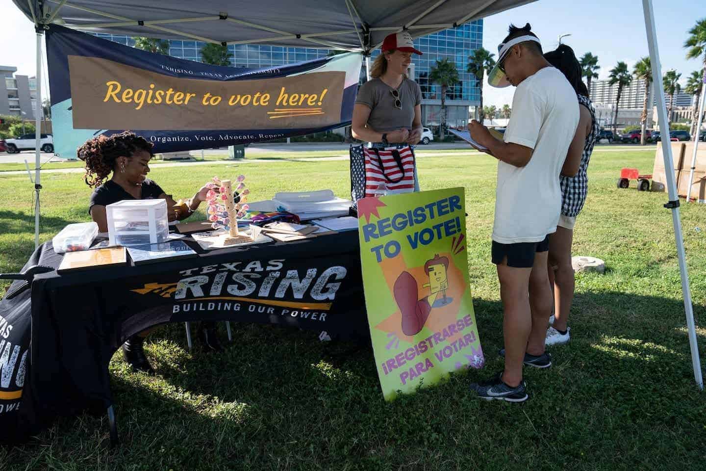 People register to vote at a tent on campus in texas