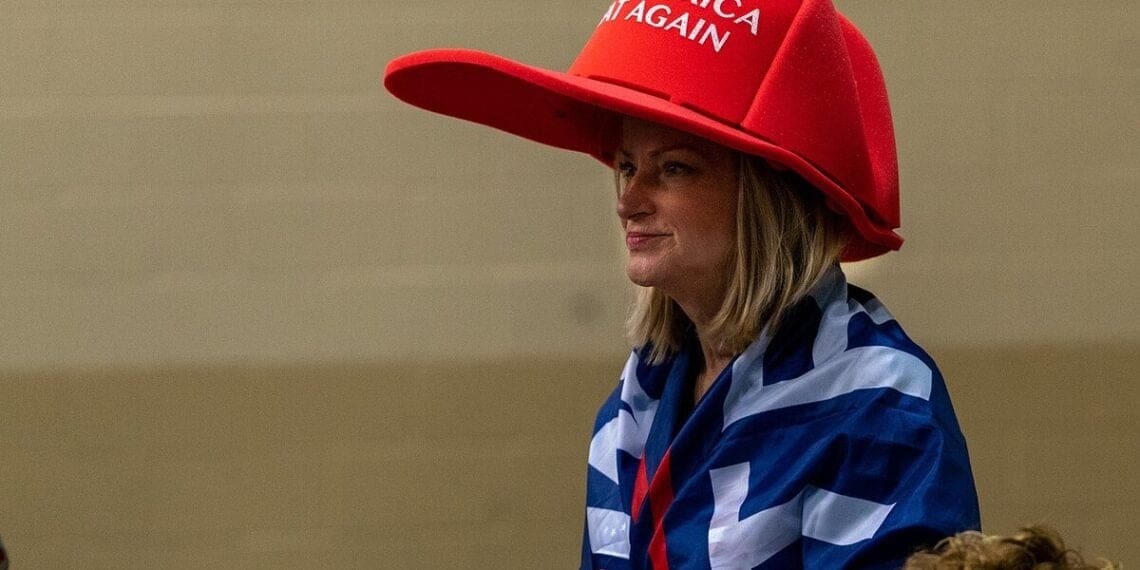 Maga woman wearing an oversized red maga hat in florid