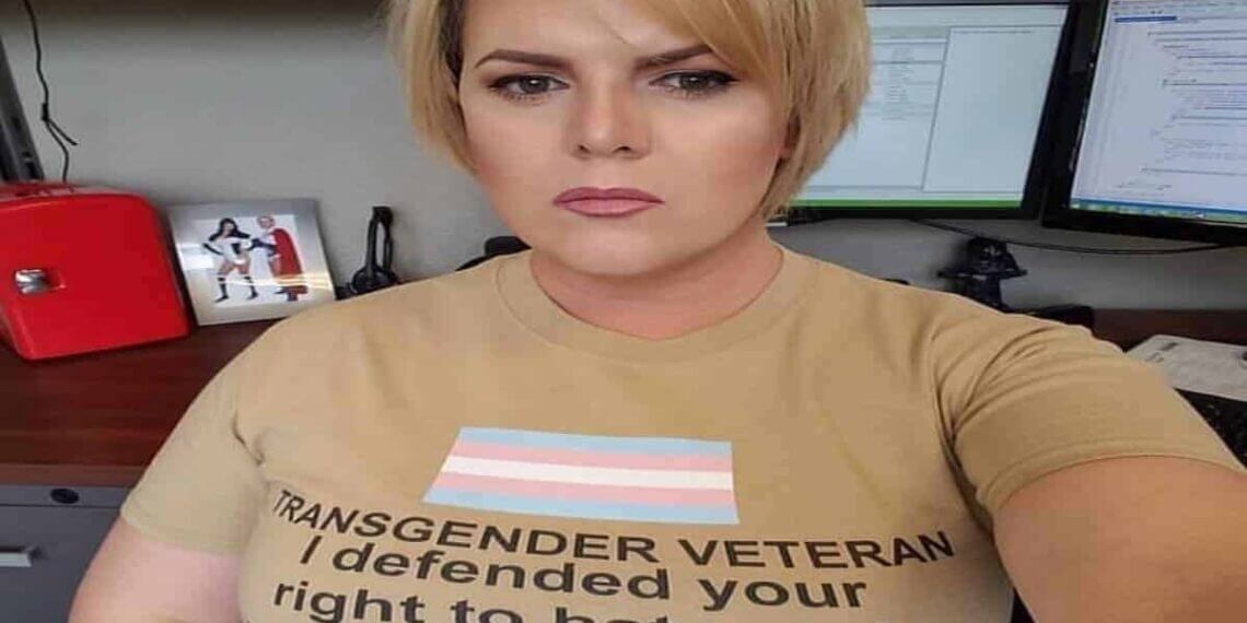 Transgender veteran wearing a shirt that says i fought for your right to hate me