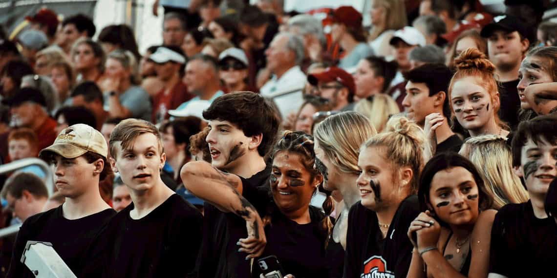 Teens/high school students at a football game.