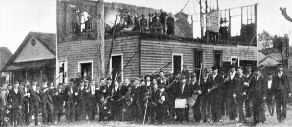 Wilmington massacre wilmington, n. C. Race riot, 1898: armed rioters in front of the burned-down "record" press building.