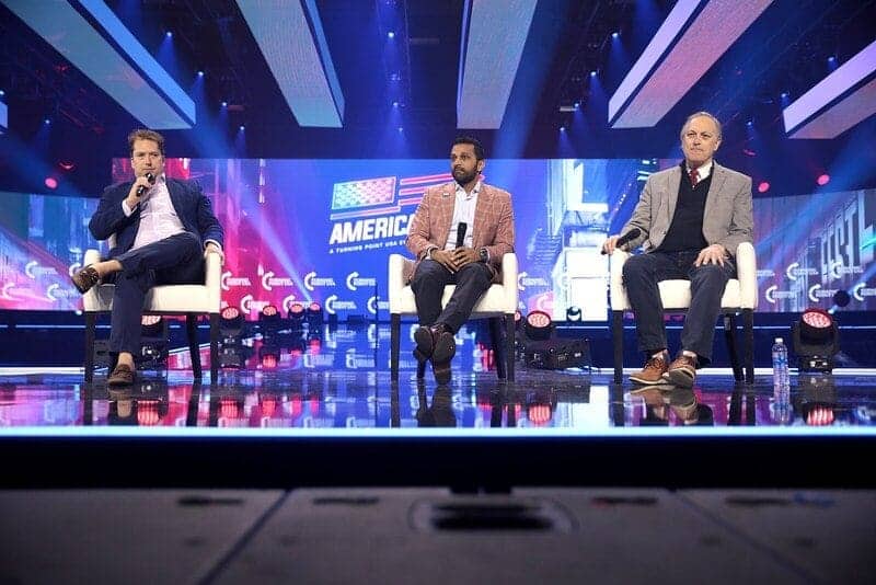 Darren beattie, kash patel and u. S. Congressman andy biggs speaking with attendees at the 2022 americafest