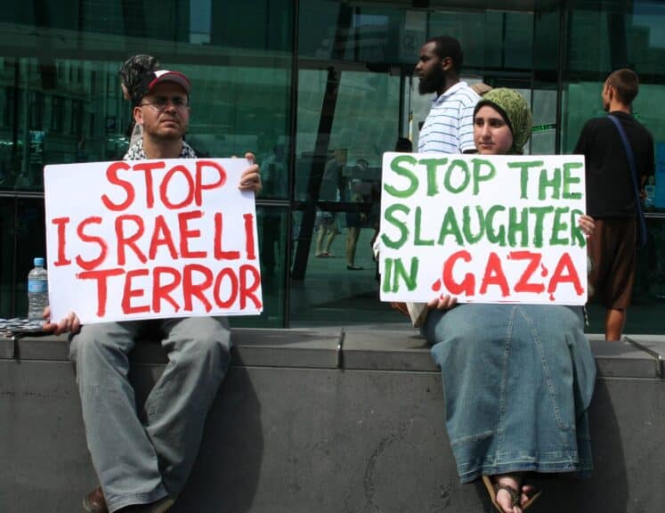 2 people protesting the slaughter in gaza