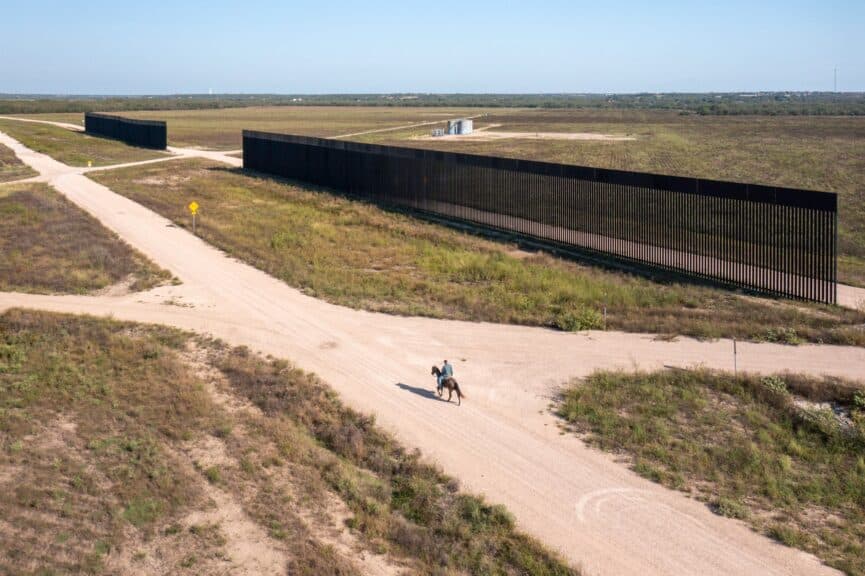 2024 in photos a man rides a horse next to border wall in starr county.