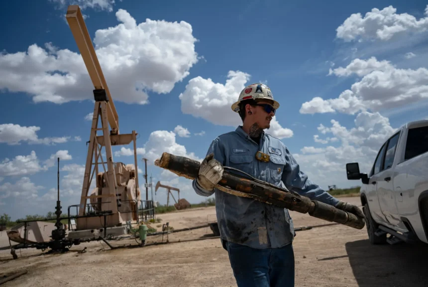 Benny ford carries a damaged tube anchor catcher to his truck from a well site outside goldsmith on aug. 14, 2024.