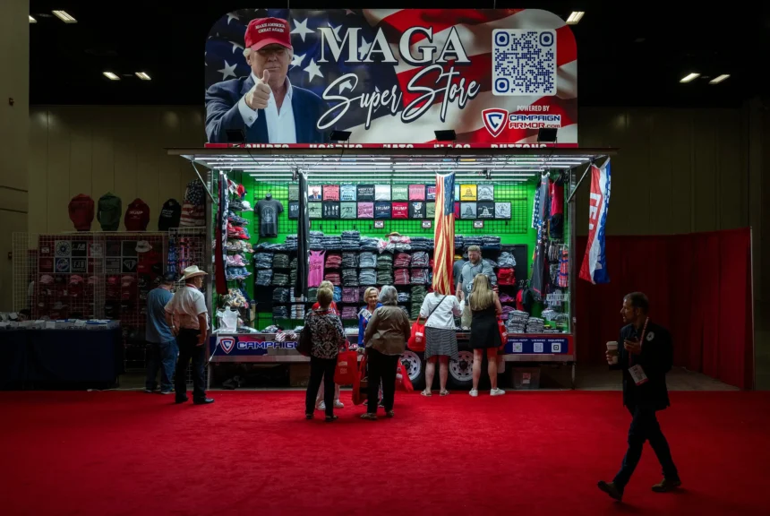 Conventioneers browse a donald trump-themed clothing stand at the texas gop convention on may 23, 2024.