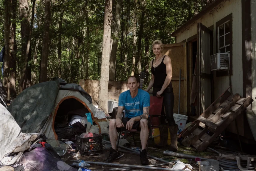 Rodger pace, left, and veronika scheid next to the tent where they’re currently living after flooding struck parts of harris county. Scheid said that if the property owner took a buyout she would have nowhere to go.