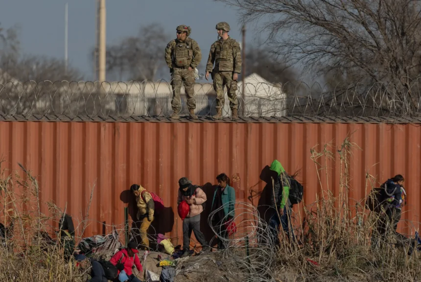 Immigrants at the border wall