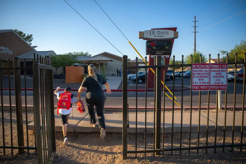 Fabiola velasquez walks her youngest child to school.