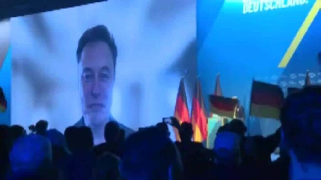 Elon musk on a large screen during an afd event in germany